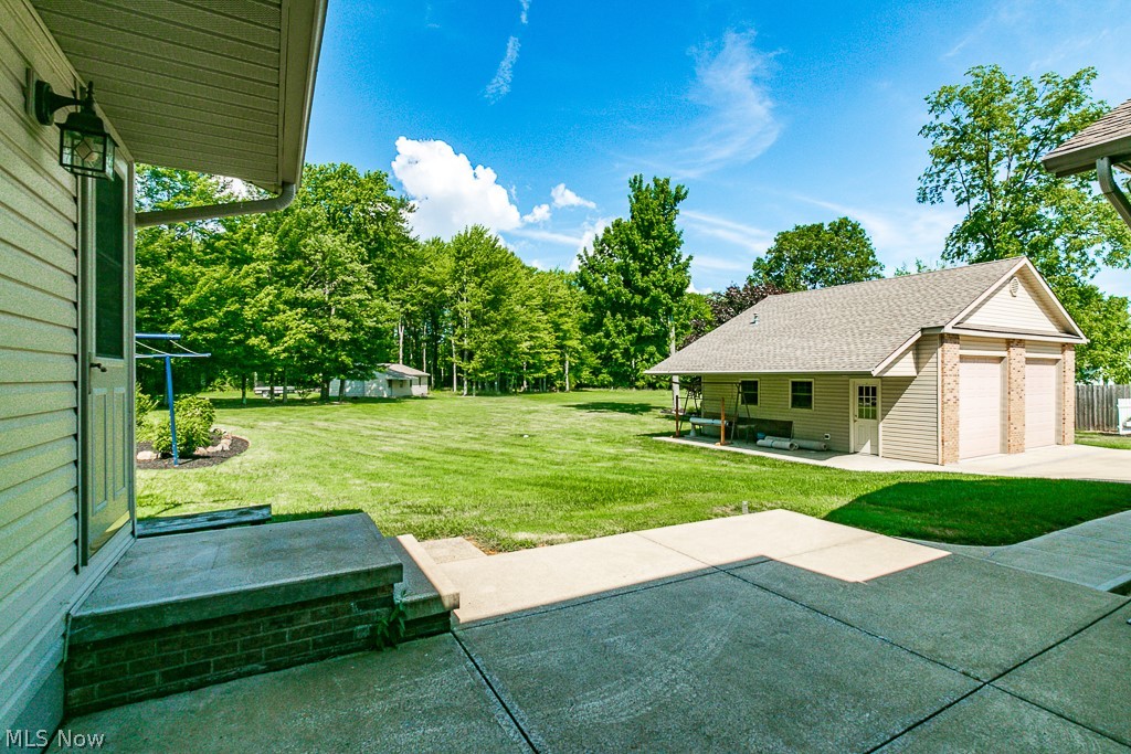 7710 Brakeman Road Painesville, OH 44077 - Photo 30 of 34 View of yard with a garage