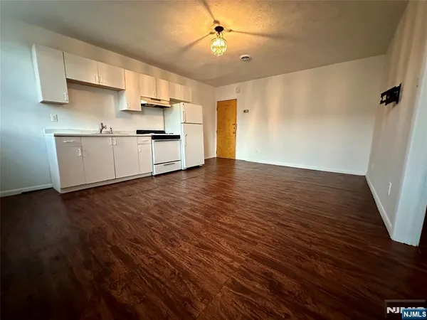 a view of kitchen with wooden floor electronic appliances and window