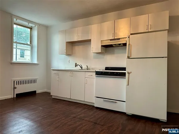 a kitchen with stainless steel appliances and white cabinets
