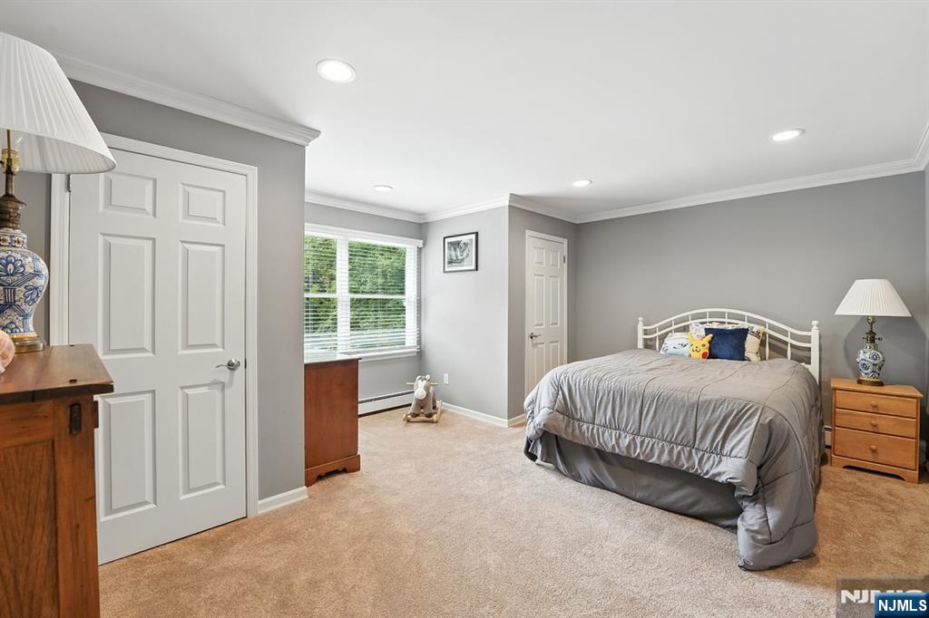 856 Stonewall Court Franklin Lakes, NJ 07417 - Photo 15 of 26 a bedroom with a bed and a window