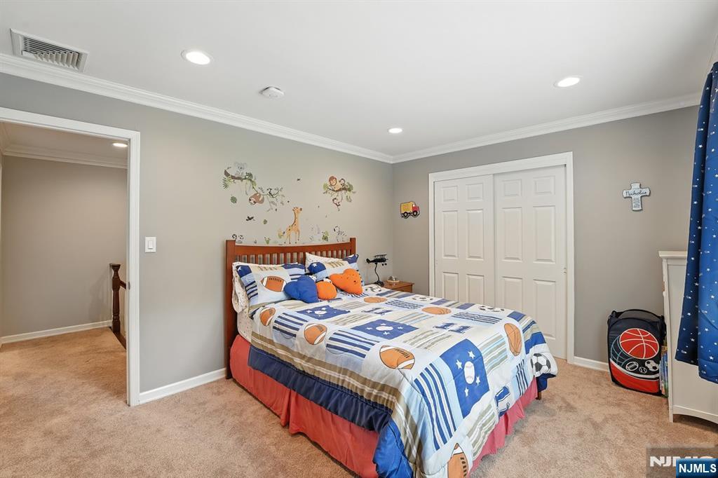 856 Stonewall Court Franklin Lakes, NJ 07417 - Photo 18 of 26 a bedroom with a bed and a window