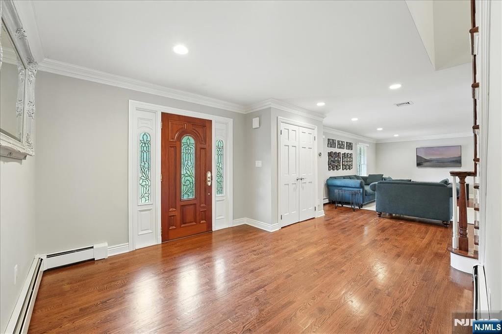 856 Stonewall Court Franklin Lakes, NJ 07417 - Photo 2 of 26 a view of an empty room with wooden floor and a window