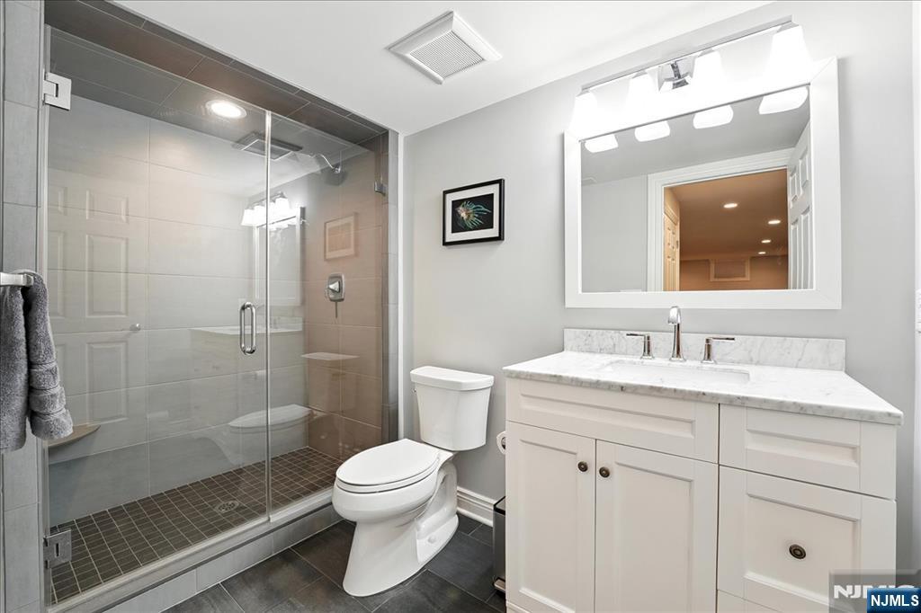 856 Stonewall Court Franklin Lakes, NJ 07417 - Photo 21 of 26 a bathroom with a sink a toilet and shower