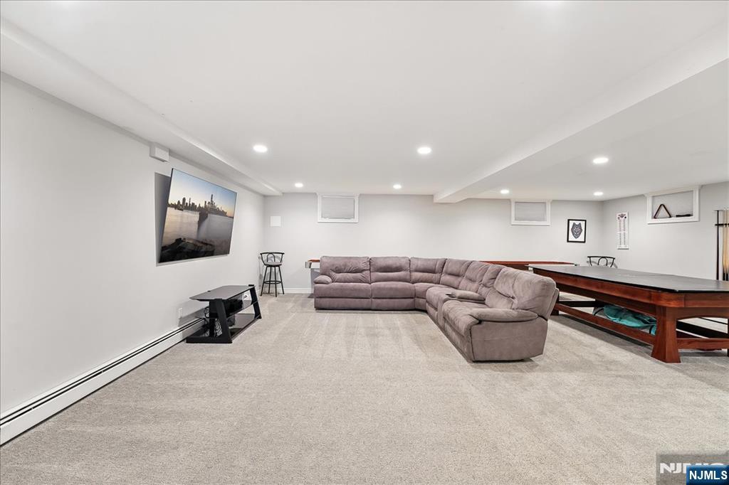 856 Stonewall Court Franklin Lakes, NJ 07417 - Photo 22 of 26 a living room with furniture and a flat screen tv