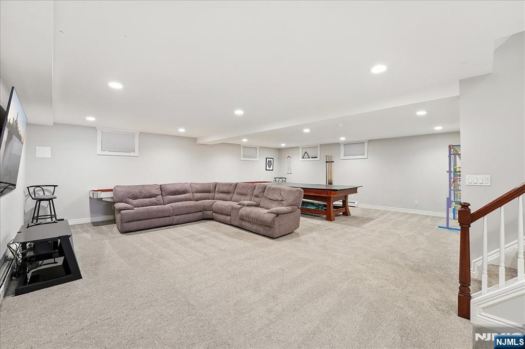 856 Stonewall Court Franklin Lakes, NJ 07417 - Photo 24 of 26 a living room with furniture and a flat screen tv