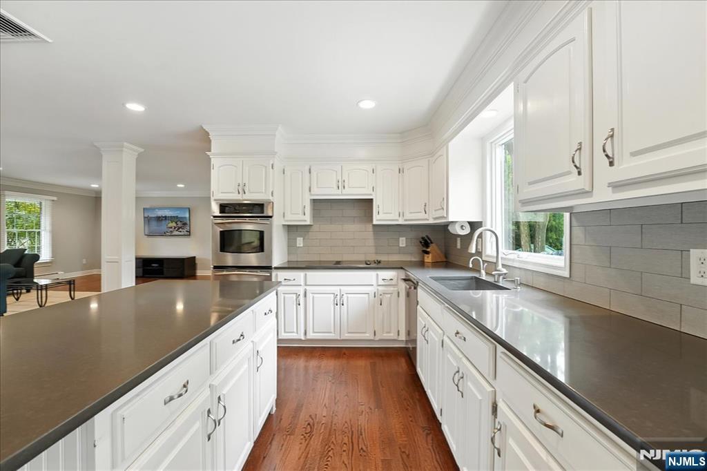 856 Stonewall Court Franklin Lakes, NJ 07417 - Photo 5 of 26 a large kitchen with stainless steel appliances granite countertop a sink dishwasher stove and refrigerator