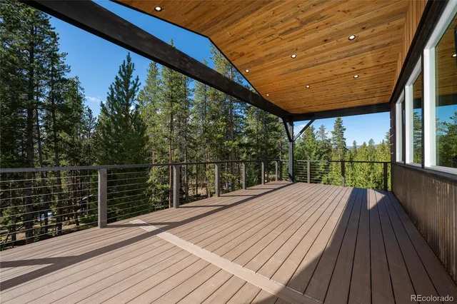 a view of balcony with wooden floor and iron fence