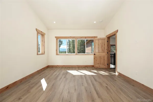 a spacious bathroom with a granite countertop sink and a mirror