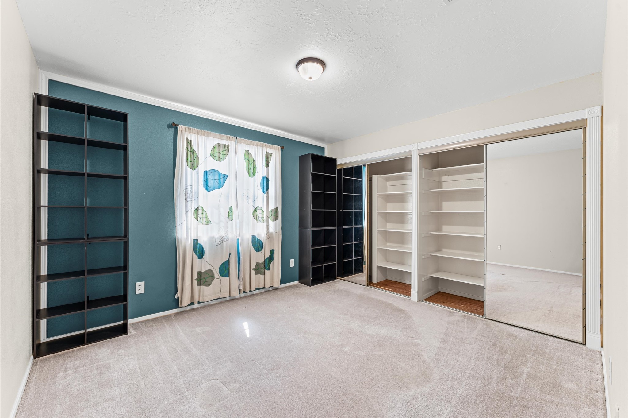 17015 Sky Blue Place Houston, TX 77095 - Photo 13 of 25 a view of an empty room with a window and storage