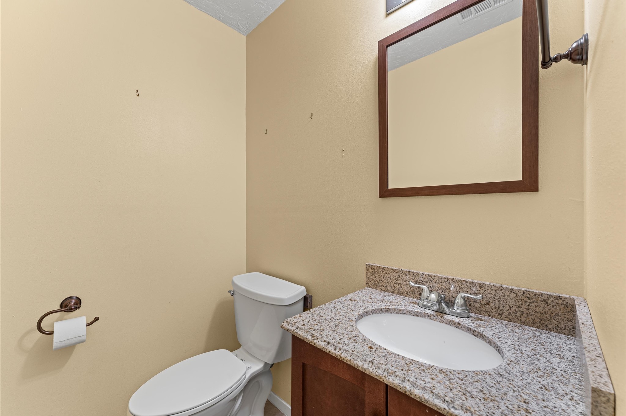 17015 Sky Blue Place Houston, TX 77095 - Photo 21 of 25 a bathroom with a granite countertop toilet sink and mirror