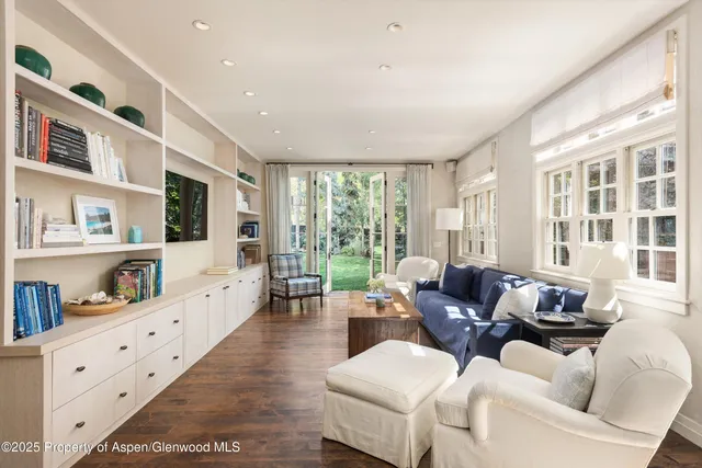 a living room with furniture large window and flat screen tv