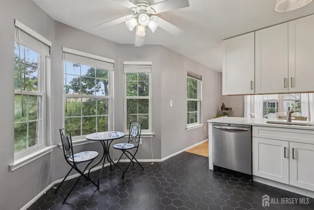 a kitchen with a table chairs and a window