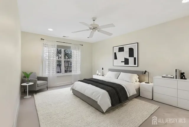 a spacious bedroom with a bed a couch and a window