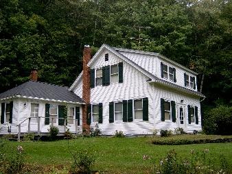 a front view of a house with a garden and porch