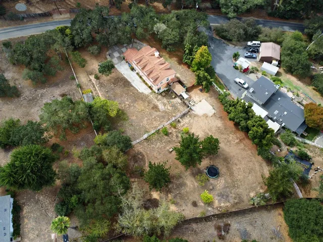 an aerial view of residential house with green space
