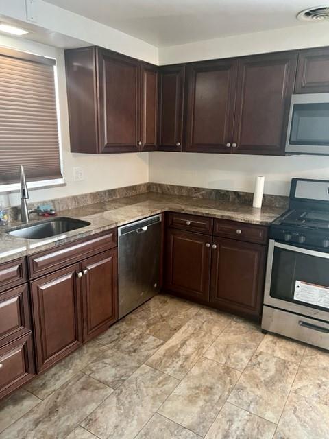 1040 5th Street Baden, PA 15005 - Photo 7 of 19 a kitchen with a sink stove top oven and cabinets