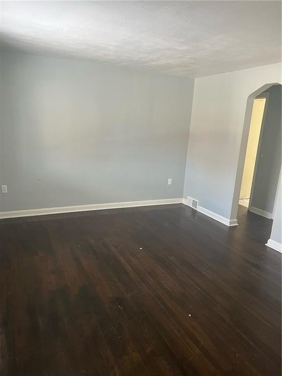 1040 5th Street Baden, PA 15005 - Photo 8 of 19 an empty room with wooden floor and door