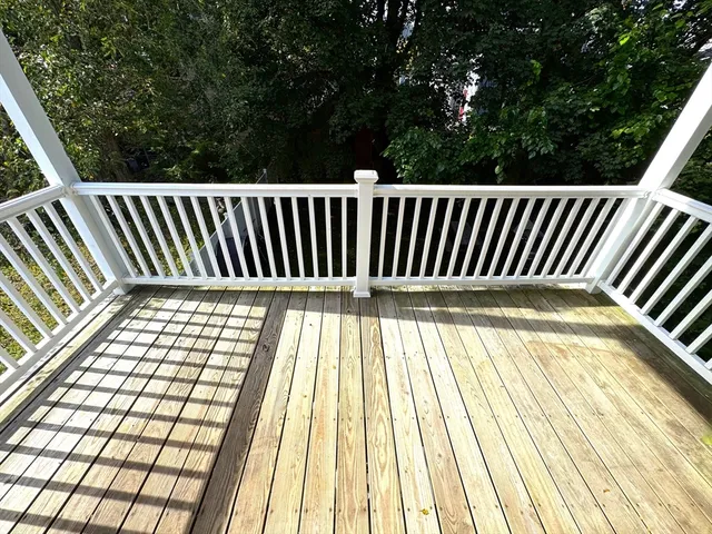 a view of balcony with wooden floor
