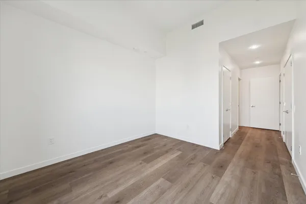 a view of a room with wooden floor