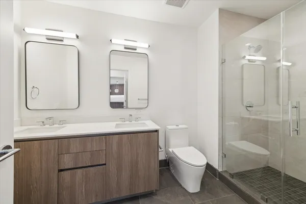 a bathroom with a toilet a sink and a mirror