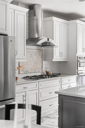 a kitchen with a stove and a white cabinets