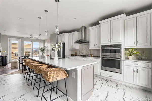 a kitchen with stainless steel appliances a sink stove and cabinets