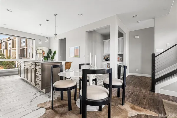 a kitchen with a table chairs and a refrigerator