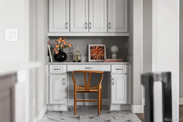 a kitchen with white cabinets and a sink