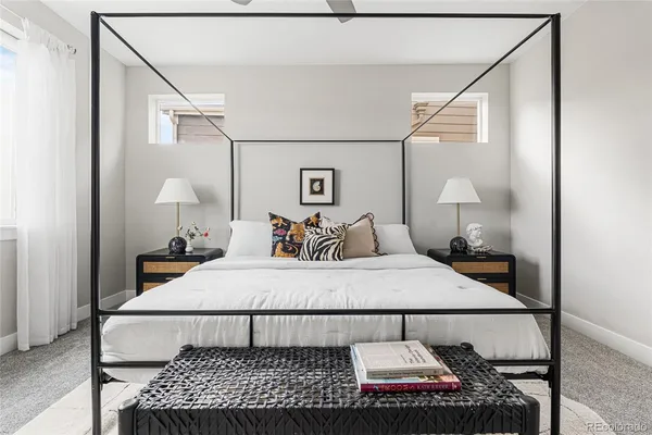 a bedroom with a bed and a lamp