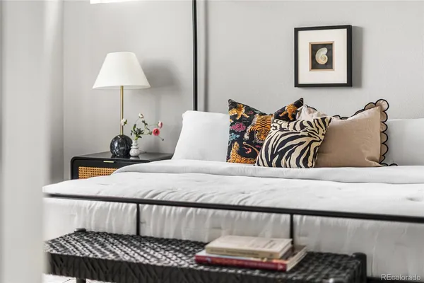 a bedroom with a bed and a chandelier