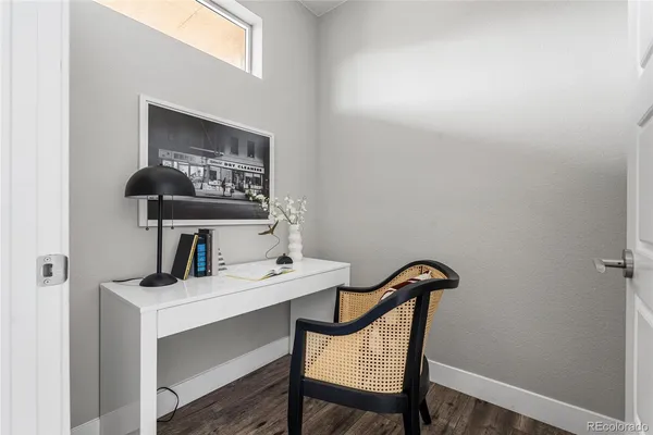 a living room with furniture and floor to ceiling windows