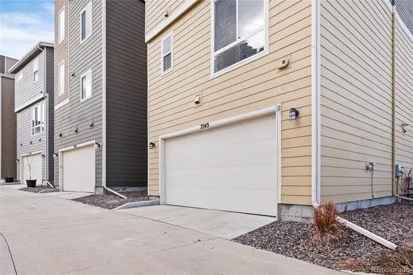 a front view of a residential apartment building with a yard