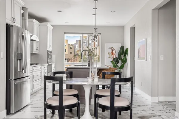 a kitchen with stainless steel appliances a sink a stove and a wooden floors