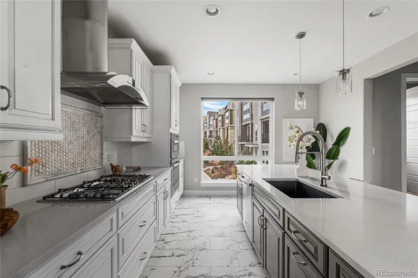 a kitchen with granite countertop white cabinets and white appliances