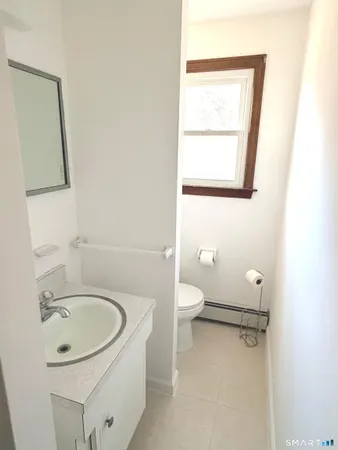 a bathroom with a sink a toilet and mirror
