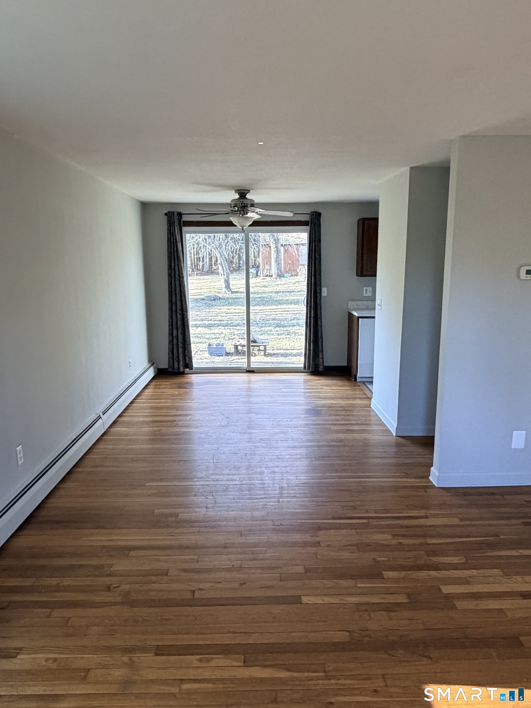 195 Wall Street Hebron, CT 06248 - Photo 17 of 23 a view of an empty room with wooden floor and a window