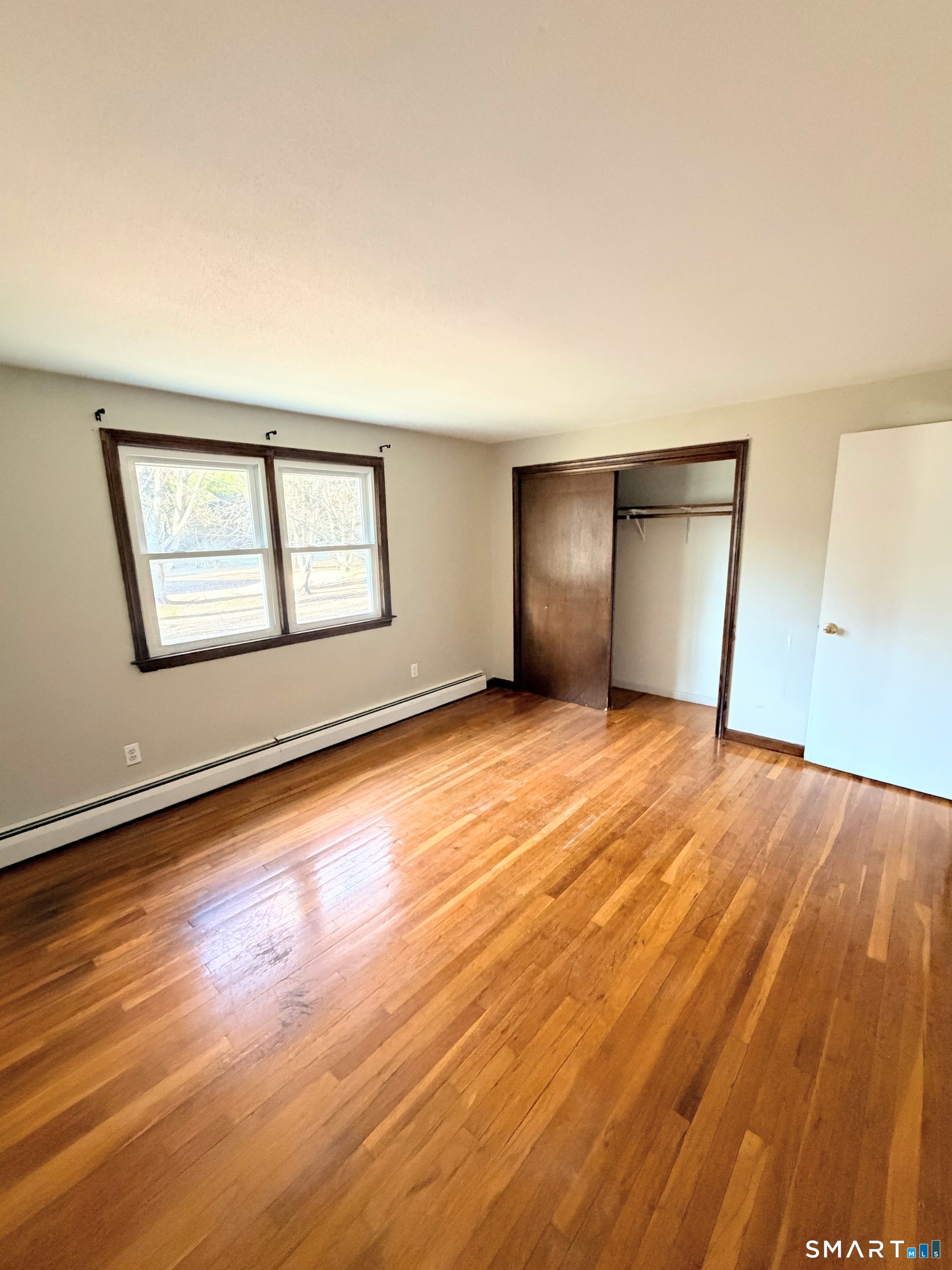 195 Wall Street Hebron, CT 06248 - Photo 21 of 23 a view of empty room with wooden floor and fan