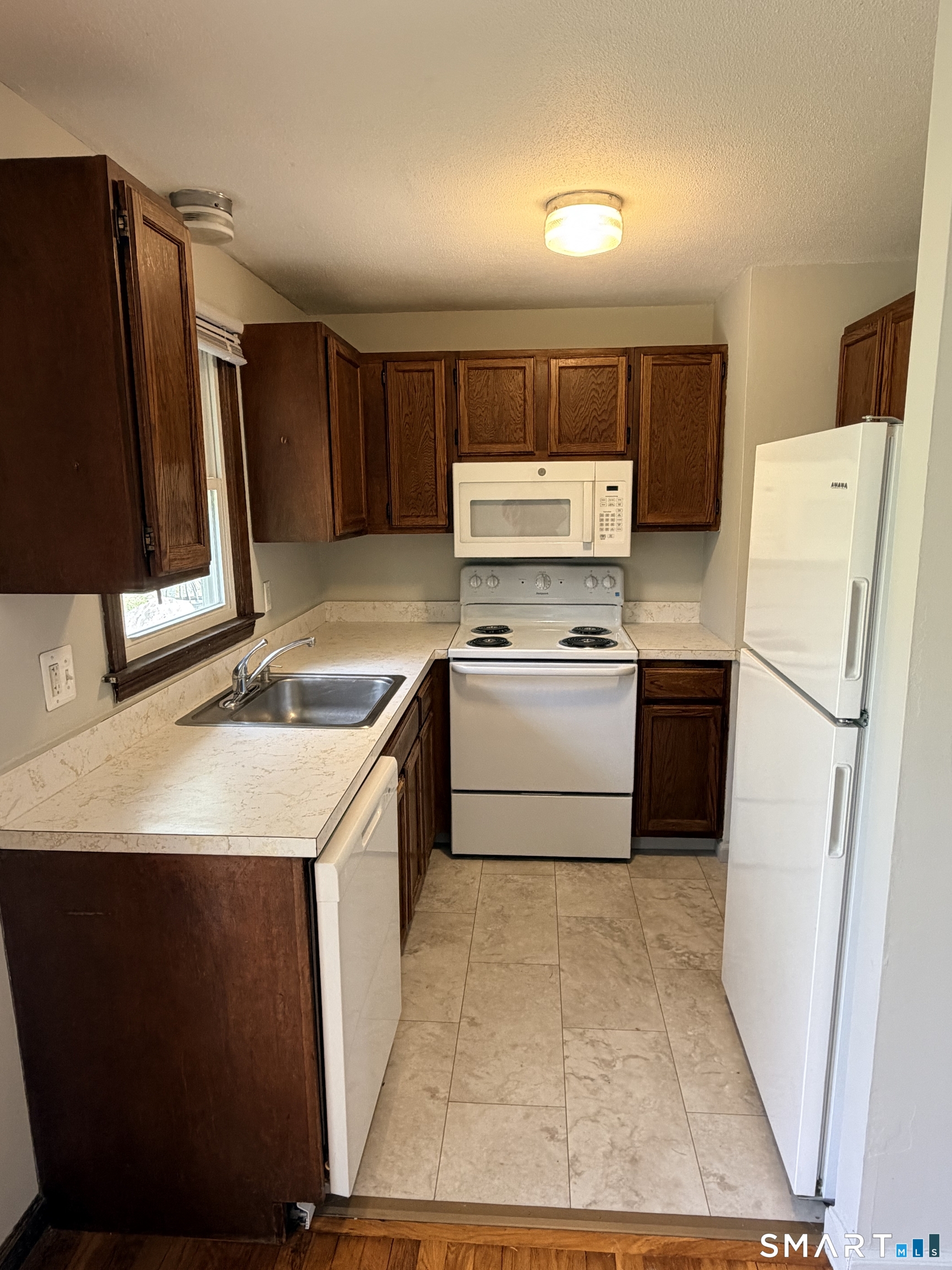 195 Wall Street Hebron, CT 06248 - Photo 4 of 23 a kitchen with a sink stove and refrigerator