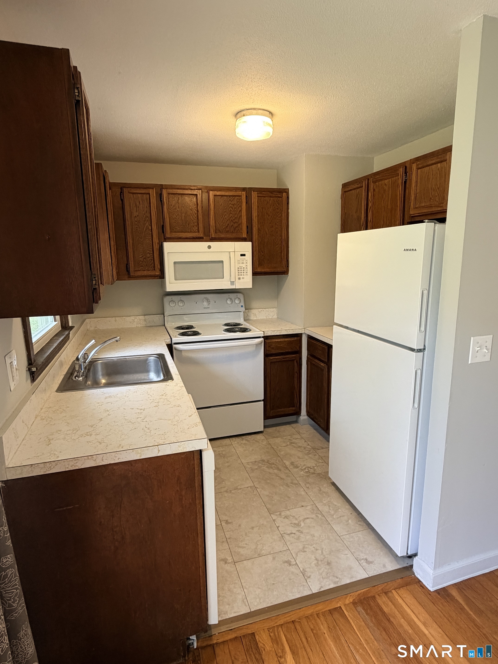 195 Wall Street Hebron, CT 06248 - Photo 6 of 23 a kitchen with a refrigerator sink and stove