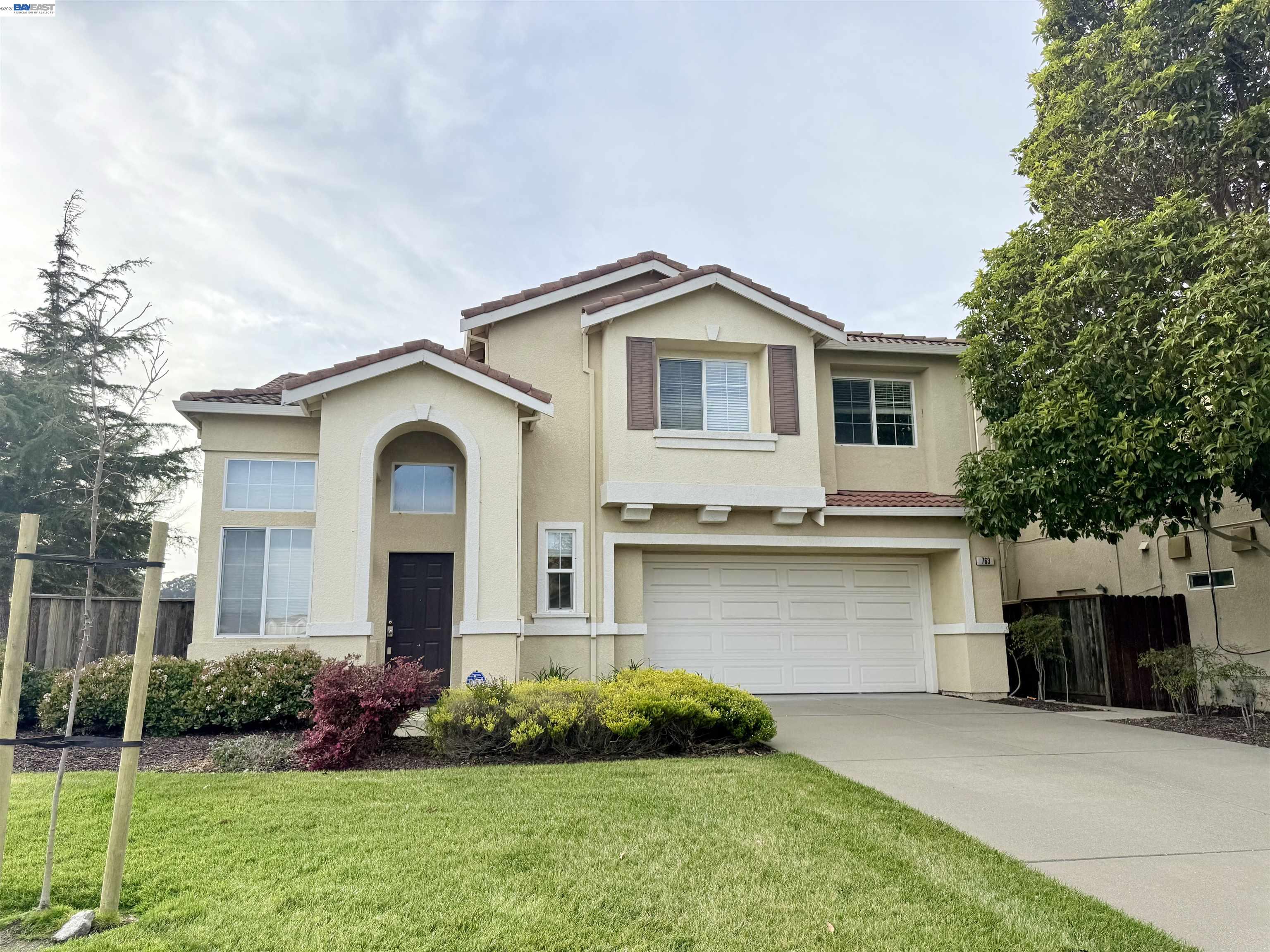 a front view of a house with a yard and garage