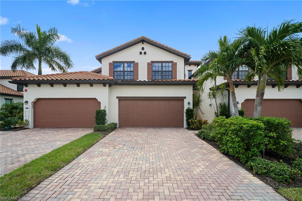 Mediterranean / spanish home featuring stucco siding, decorative driveway, a tiled roof, and an attached garage