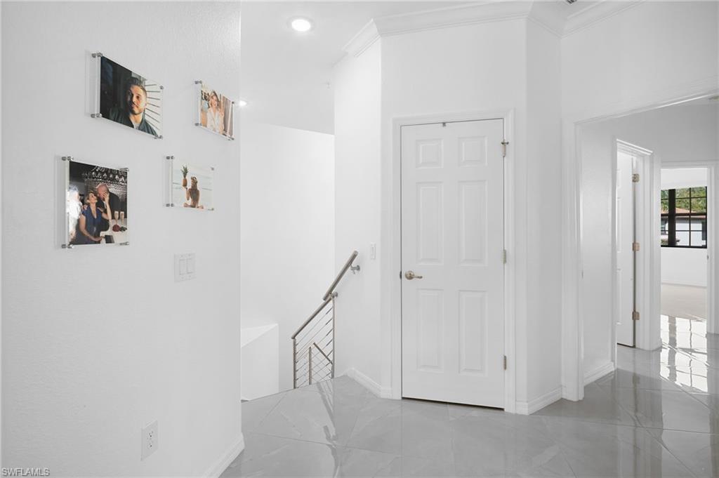 11879 Arboretum Run Drive, Unit 201 Fort Myers, FL 33913 - Photo 18 of 37 Corridor with an upstairs landing, light tile patterned flooring, crown molding, and recessed lighting