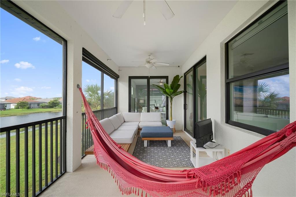 11879 Arboretum Run Drive, Unit 201 Fort Myers, FL 33913 - Photo 20 of 37 Sunroom featuring a water view and carpet floors