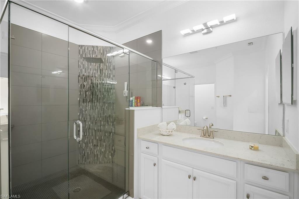 11879 Arboretum Run Drive, Unit 201 Fort Myers, FL 33913 - Photo 29 of 37 Full bath featuring vanity, a shower stall, and crown molding