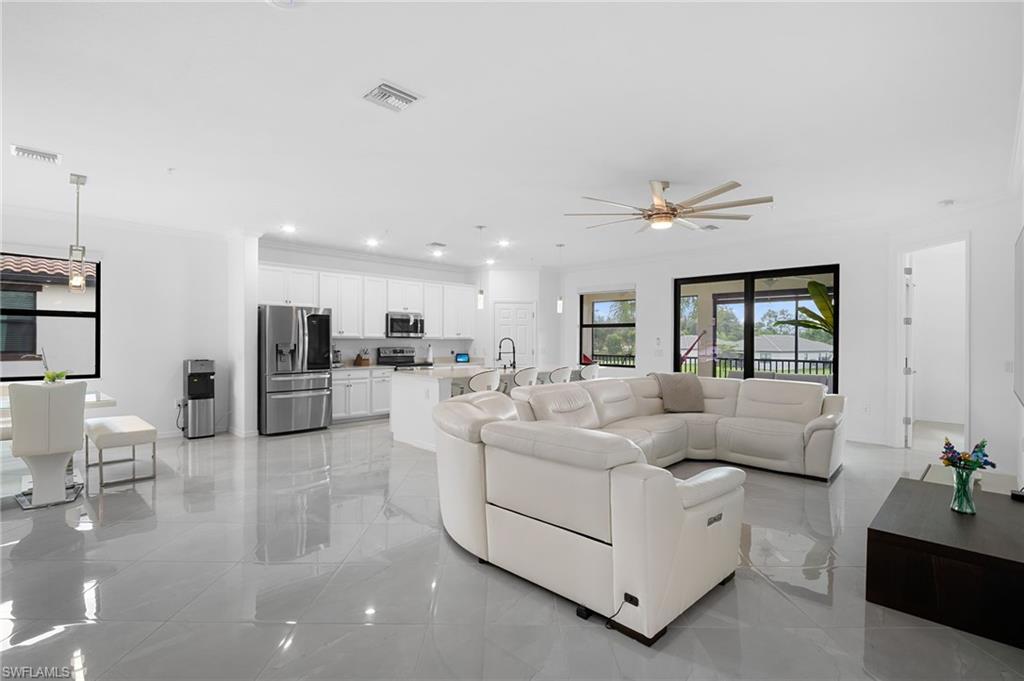 11879 Arboretum Run Drive, Unit 201 Fort Myers, FL 33913 - Photo 3 of 37 Living area featuring a ceiling fan, recessed lighting, and light marble finish floors