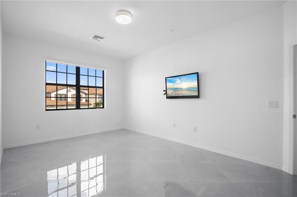11879 Arboretum Run Drive, Unit 201 Fort Myers, FL 33913 - Photo 34 of 37 Spare room featuring baseboards