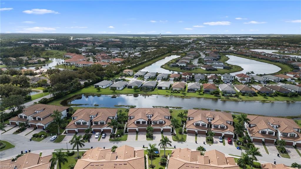 11879 Arboretum Run Drive, Unit 201 Fort Myers, FL 33913 - Photo 36 of 37 Aerial view of property and surrounding area with a nearby body of water and nearby suburban area