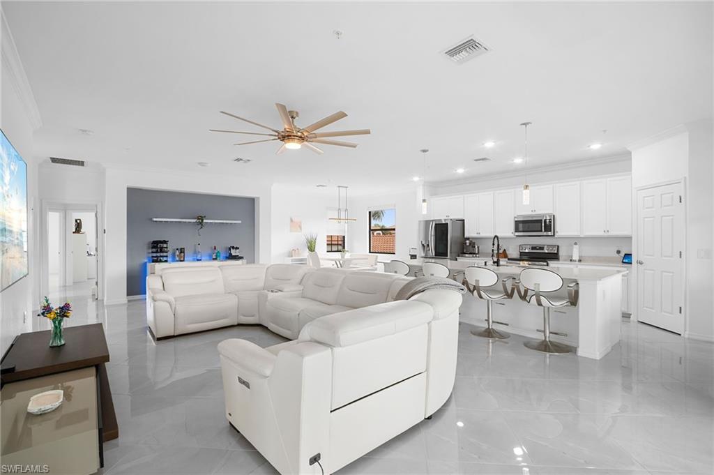 11879 Arboretum Run Drive, Unit 201 Fort Myers, FL 33913 - Photo 4 of 37 Living area with ceiling fan, crown molding, and recessed lighting