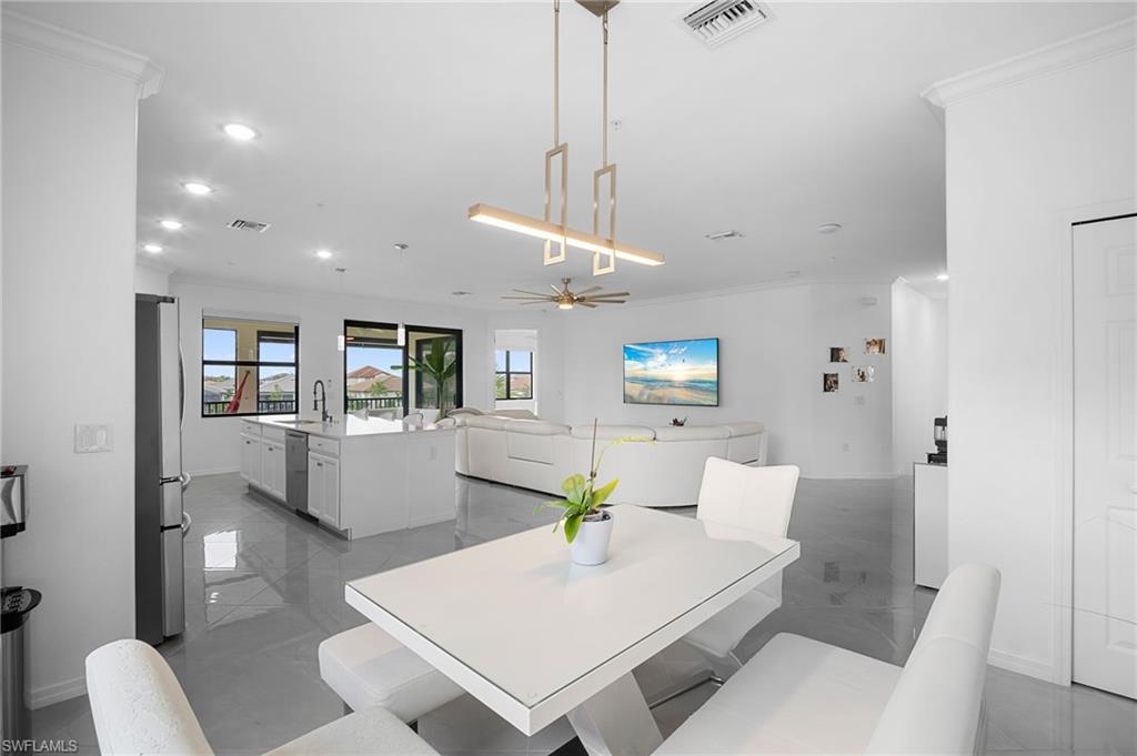 11879 Arboretum Run Drive, Unit 201 Fort Myers, FL 33913 - Photo 5 of 37 Dining room with crown molding, ceiling fan, and recessed lighting