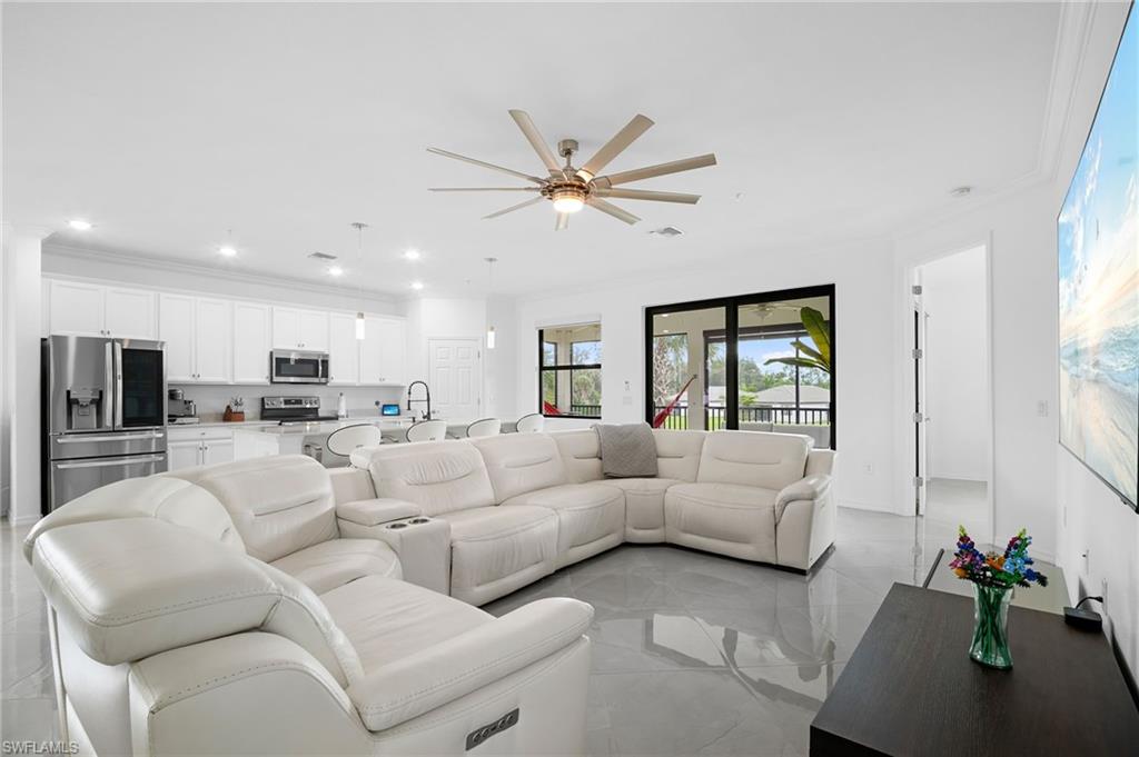 11879 Arboretum Run Drive, Unit 201 Fort Myers, FL 33913 - Photo 7 of 37 Living area with ornamental molding, ceiling fan, recessed lighting, and light tile patterned floors